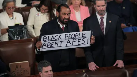 WASHINGTON, DC - FEBRUARY 24: Rep. Al Green (D-TX) holds up a sign as Trump delivers his State of the Union address during a Joint Session of Congress at the U.S. Capitol on February 24, 2026, in Washington, DC. Trump delivered his address days after the Supreme Court struck down the administration's tariff strategy and amid a U.S. military buildup in the Persian Gulf threatening Iran.   Chip Somodevilla/Getty Images/AFP (Photo by CHIP SOMODEVILLA / GETTY IMAGES NORTH AMERICA / Getty Images via AFP)