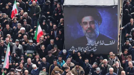 A screen displays a portrait of Iran's new supreme leader Mojtaba Khamenei during the funerals of Iran's Revolutionary Guards Corps (IRGC) commanders, army commanders and others killed in the early days of the United States and Israeli strikes on Iran, at Enghelab Square in Tehran on March 11, 2026. Washington launched strikes with Israel on Iran on February 28, sparking retaliatory strikes by Tehran against Israel and US bases across the Gulf region. (Photo by ATTA KENARE / AFP) / Attention editors: Photo taken with approval from the Ministry of Culture and Islamic Guidance (Ershad) --AFP covers the war in the Middle East through its extensive regional network, including bureaus in Tehran, Jerusalem, and several neighboring countries. Since the start of the conflict, journalists have been working under increasingly restrictive conditions. Authorities in several countries have limited reporters' movements, photo and live video coverage from sensitive locations. Some governments and armed groups have banned images of missile or drone strikes and other security-related sites. /