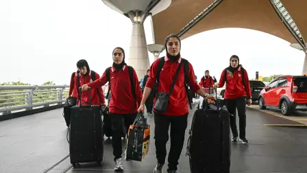 Members of Iran's women's football team arrive at the Kuala Lumpur International Airport in Sepang on March 16, 2026, after staying in a hotel in the Malaysian capital while awaiting the next leg of their journey home. Three more members of the Iranian women's football team have left their asylum in Australia and decided to return home, Canberra said on March 15. (Photo by MOHD RASFAN / AFP)