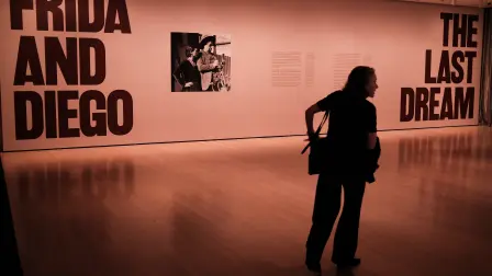 A visitor attends a press preview of the exhibition "Frida and Diego: The Last Dream" at the Museum of Modern Art (MoMA) in New York City on March 16, 2026. New Yorks Museum of Modern Art (MoMA) is bringing together works by Mexican artist couple Frida Kahlo and Diego Rivera for the first time, in an exhibition that serves as a prelude to an opera inspired by the two figures, to be performed in May at the Met Opera.Drawn from the museums collections, the paintings and drawings on view starting Martch 21 set up a dialogue between the works of these two giants of 20th century Mexican art, who lived through a tumultuous love affair while mutually influencing each other artistically. (Photo by CHARLY TRIBALLEAU / AFP) / RESTRICTED TO EDITORIAL USE - MANDATORY MENTION OF THE ARTIST UPON PUBLICATION - TO ILLUSTRATE THE EVENT AS SPECIFIED IN THE CAPTION