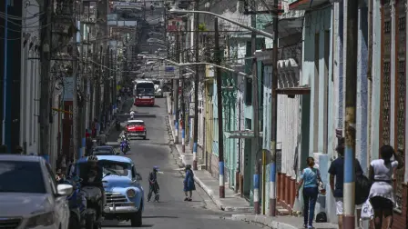 People walk down a street in Matanzas, Cuba, on March 31, 2026. (Photo by YAMIL LAGE / AFP)
