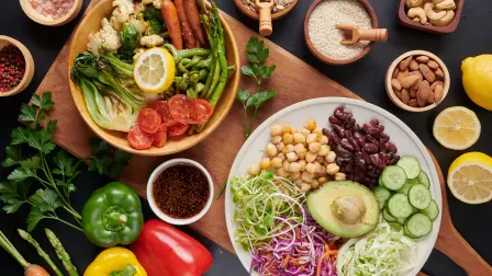 Vegan protein source. Buddha bowl dish, avocado, pepper, tomato, cucumber, red cabbage, chickpea, fresh lettuce salad and walnuts, nuts, beans, . Healthy vegetarian eating, super food. Top view.