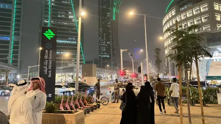 People walk along Riyadh's commercial Tahlia Street late at night on April 4, 2026. The oil-rich Gulf has borne the brunt of Iran's attacks in response to US-Israeli strikes that sparked the Middle East war, with Tehran targeting US assets but also civilian infrastructure, including energy facilities and airports. (Photo by Fayez Nureldine / AFP)
