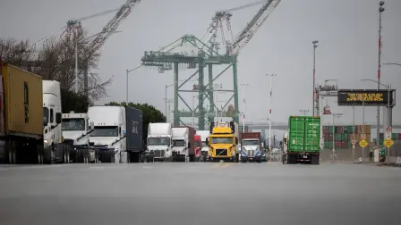 FILE PHOTO: Trucks carrying shipping containers wait in line at the port of Oakland following the Supreme Court's ruling that Trump had exceeded his authority when he imposed tariffs, in Oakland, California, U.S., February 23, 2026. REUTERS/Carlos Barria/File Photo