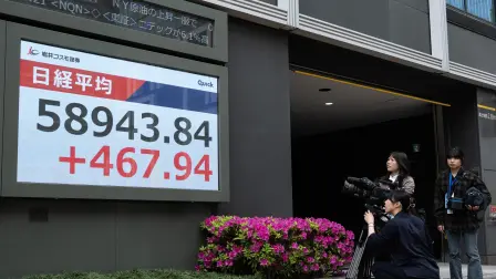 A camera crew films a display of the Nikkei Stock Average near the Tokyo Stock Exchange in Tokyo on April 20, 2026. (Photo by Andrew CABALLERO-REYNOLDS / AFP)