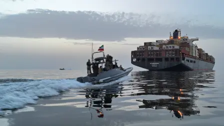 This photo obtained by AFP from the Iranian news agency Tasnim shows an Islamic Revolutionary Guard Corps (IRGC) boat allegedly taking part in an operation to seize ships attempting to cross the Strait of Hormuz, on April 21, 2026. Oil prices had been climbing earlier as investors worried about a lack of progress in ending the Middle East crisis, with Tehran keeping the Strait of Hormuz closed and the US maintaining a blockade of Iranian ports. (Photo by Meysam MIRZADEH / TASNIM NEWS / AFP) /
