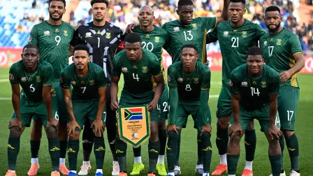 South Africa's forward #09 Lyle Foster, South Africa's goalkeeper #01 Ronwen Williams, South Africa's defender #20 Khuliso Mudau, South Africa's midfielder #13 Sphephelo Yaya Sithole, South Africa's defender #21 Siyabonga Ngezana, South Africa's midfielder #17 Sipho Mbule and South Africa's defender #06 Aubrey Modiba, South Africa's midfielder #07 Oswin Appollis, South Africa's midfielder #04 Teboho Mokoena, South Africa's forward #08 Tshepang Moremi and South Africa's defender #14 Mbekezeli Mbokazi line up ahead of the Africa Cup of Nations (CAN) Group B football match between Zimbabwe and South Africa at Marrakesh Stadium in Marrakesh on December 29, 2025. (Photo by Khaled DESOUKI / AFP)
