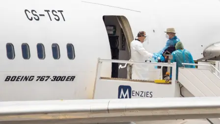 Canadian passengers board a plane at the Tenerife Sur-Reina Sofia airport after being evacuated from the Dutch flagged hantavirus-stricken cruise ship MV Hondius on the island of Tenerife in Spain's Canary Islands on May 10, 2026. Repatriation flights for the nearly 150 passengers onboard the ship hit by a deadly hantavirus outbreak got underway as passengers and some crew members were transferred to shore on smaller vessels then by bus to the airport and then flown home after weeks at sea. (Photo by Antonio Sempere / AFP)