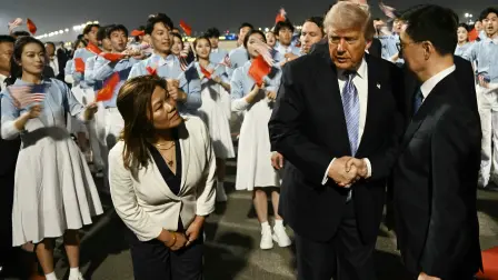 US President Donald Trump (C) is greeted by Chinas Vice President Han Zheng upon arriving at Beijing Capital Airport in Beijing on May 13, 2026. (Photo by Brendan SMIALOWSKI / AFP)