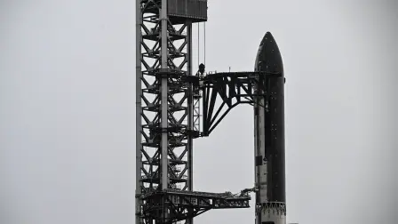 SpaceX's new Starship V3 rocket is seen docked at the Starbase during the 12th test flight on May 21, 2026 as seen from South Padre Island in Texas. Elon Musk's SpaceX is set for the debut launch of its latest Starship iteration on Thursday, testing the most powerful version yet of the megarocket as the company targets a blockbuster initial public offering. (Photo by RONALDO SCHEMIDT / AFP)