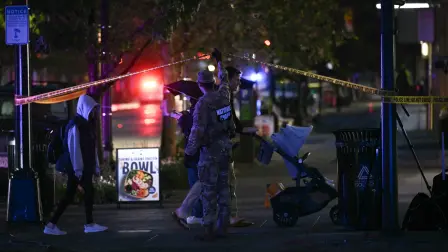 A member of the National Guard guides a family pushing a child in a stroller near the White House after a gunman opened fire in Washington, DC, on May 23, 2026. A gunman who opened fire on Secret Service officers outside the White House on the evening of May 23 has died after being shot, the agency said in a statement provided to US media. A bystander was also shot during the exchange of fire, the agency said, without providing the victim's condition. (Photo by Brendan SMIALOWSKI / AFP)