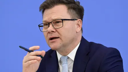 German Minister for the Environment, Climate Protection, Nature Conservation and Nuclear Safety Carsten Schneider delivers a press conference to present his report 'Program for Climate Protection 2026' at the BPK (Bundespressekonferenz) building in Berlin, on March 25, 2026. (Photo by John MACDOUGALL / AFP)