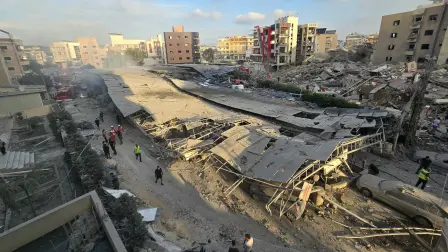 First responders gather at the site of an Israeli strike that hit near a hospital in the southern Lebanese city of Tyre on June 1, 2026. Lebanon said an Israeli strike hit near a hospital in the southern city of Tyre on June 1 as the health ministry shared footage showing heavy damage to the facility. The state-run National News Agency said a strike targeting an intersection near the Jabal Amel hospital "hit a building and the parking lot, resulting in a number of wounded". (Photo by KAWNAT HAJU / AFP)