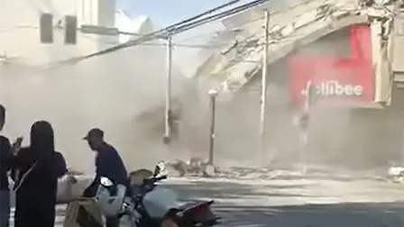 This frame grab made from UGC video footage courtesy of Queenie Rose Adaya shows bystanders reacting to the collapse of a Jollibee fast food restaurant in an 7.8 magnitude earthquake in General Santos City on June 8, 2026. A 7.8-magnitude earthquake that struck the southern Philippines on June 8 killed at least one person and collapsed buildings, police said, as the disaster sparked tsunami warnings across the region. (Photo by Queenie Rose Adaya / Courtesy of Queenie Rose Adaya / AFP) / RESTRICTED TO EDITORIAL USE - MANDATORY CREDIT "AFP PHOTO / COURTESY OF QUEENIE ROSE ADAYA" - HANDOUT - NO MARKETING NO ADVERTISING CAMPAIGNS - DISTRIBUTED AS A SERVICE TO CLIENTS - NO ARCHIVE