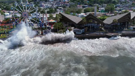 An aerial view shows rough seas near the port of La Libertad ahead of the arrival of Tropical Storm Cristina in La Libertad, El Salvador, on June 9, 2026. The approach of Tropical Storm Cristina on June 9 forced the closure of restaurants and the suspension of fishing activities in the port of La Libertad as part of measures taken by Salvadoran authorities ahead of possible severe weather conditions, according to AFP journalists. (Photo by Rudy QUIROZ / AFP)