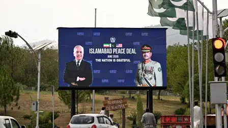 Commuters ride past an electronic board featuring Pakistan's Prime Minister Shehbaz Sharif (L) with Army Chief and Field Marshal Syed Asim Munir, displayed along a roadside in Islamabad on June 17, 2026, after the USIran peace deal announcement. Top officials from the United States and Iran will meet at a luxury mountainside resort in Switzerland on June 19, to sign a deal -- which Pakistan has helped mediate -- to bring the Middle East war to an end. (Photo by Aamir QURESHI / AFP)