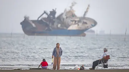 In this picture obtained from Iran's ISNA news agency on June 1, 2026, Iranians sit on Suru Beach in Bandar Abbas along the Strait of Hormuz. The United States and Iran traded strikes as negotiations between the two sides stalled and Tehran again insisted any peace deal must also cover Israel's escalating offensive into Lebanon. (Photo by AMIRHOSSEIN KHORGOOEI / ISNA / AFP) /