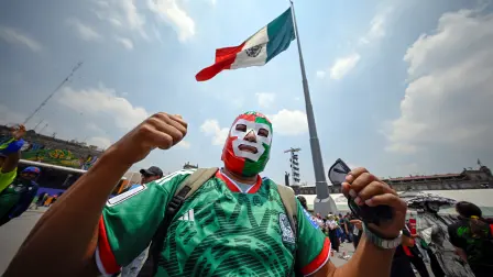 A Mexican fan wearing a lucha libre mask poses for a photograph at the FIFA Fan Festival during the 2026 World Cup in Mexico Citys Zocalo on June 18, 2026. (Photo by Alfredo ESTRELLA / AFP)