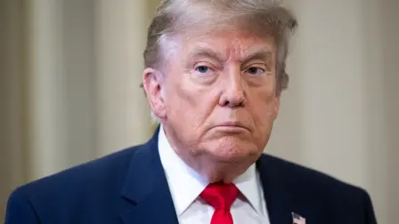 US President Donald Trump speaks to the press on the way to a lunch meeting with Senate Republicans at the US Capitol in Washington, DC, on June 24, 2026. President Trump said Wednesday he will refuse to sign a landmark housing bill, passed by Congress with broad bipartisan support, until lawmakers approve legislation that would overhaul American elections and restrict voter registration. (Photo by SAUL LOEB / AFP)