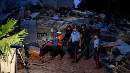 First responders search for victims in a collapsed building following an earthquake in Caracas on June 24, 2026. A magnitude 7.1 earthquake struck Venezuela on Wednesday, the United States Geological Survey (USGS) reported, triggering panic in Caracas, according to AFP journalists. The tremor, which was followed by several aftershocks, was also felt in Colombia. (Photo by Juan BARRETO / AFP)