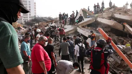 Bomberos y voluntarios trabajan entre los escombros de un edificio derrumbado tras los terremotos que azotaron el país.