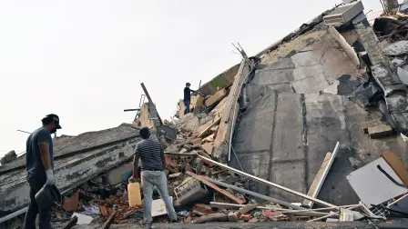 Residents search for belongings among the rubble of a collapsed building in Caraballeda, La Guaira state, Venezuela, on July 2, 2026, eight days after twin earthquakes. Hundreds of rescuers in Venezuela cheered and embraced on July 2, 2026 after pulling 43-year-old Hernan Gil from the ruins of a collapsed building eight days after deadly twin earthquakes, AFP journalists witnessed. (Photo by MARTIN BERNETTI / AFP)
