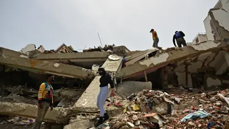 Relatives of missing people look for their corpses at the site of collapsed buildings in Caraballeda, state of La Guaira, Venezuela, on July 10, 2026, following the June 24 twin earthquakes. The death toll from the powerful double earthquake has risen to at least 3,889, whilst the number of injured remains at almost 17,000, and nearly 18,000 people were left homeless according to the last official reports. (Photo by MARTIN BERNETTI / AFP)
