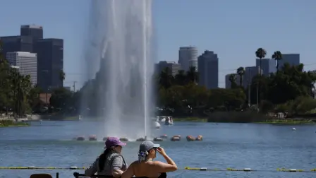 LOS ANGELES, CALIFORNIA - JULY 08: Park visitors sit on a bench at Echo Park on July 08, 2026 in Los Angeles, California. A heat advisory issued by the National Weather Service remained in effect for much of the Los Angeles area on Wednesday as temperatures were forecast to climb into the 90s and low 100s, increasing the risk of heat-related illness. The advisory was extended until 10:00 a.m. PDT on Tuesday, July 14 for the Los Angeles County Inland Coast, including downtown Los Angeles.   Justin Sullivan/Getty Images/AFP (Photo by JUSTIN SULLIVAN / GETTY IMAGES NORTH AMERICA / Getty Images via AFP)