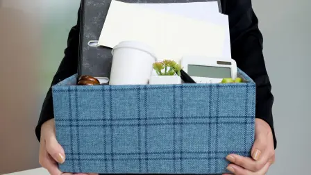 business woman packing personal company belongings when she deciding resignation and changing work in future.