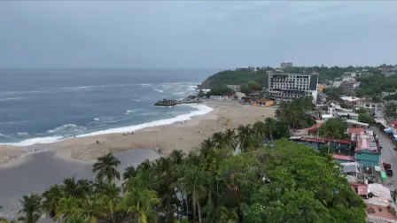 This frame grab from AFPTV video footage shows the popular tourist town of Puerto Escondido as Hurricane Erick approaches Mexico's Pacific coast as a powerful Category 3 storm in Oaxaca state, Mexico on June 18, 2025. Hurricane Erick barreled down on Mexico's Pacific coast Wednesday having strengthened to a powerful Category 3 storm, the US National Hurricane Center said, warning of potentially deadly floods. (Photo by Carlo ECHEGOYEN / AFPTV / AFP)