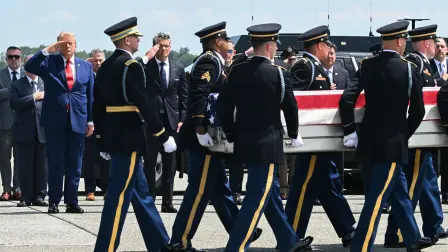US President Donald Trump and Secretary of Defense Pete Hegseth salute as a US Army carry team carries the flag-draped transfer case containing the remains of Sgt. Michael Emmanuel Swinton, 30, of Fayetteville, North Carolina, during a dignified transfer solemn event for US service members killed during operations in the Middle East, at Dover Air Force Base in Dover, Delaware, on July 22, 2026. Swinton was killed in action on July 19 at at Erbil Air Base in Iraq. (Photo by SAUL LOEB / AFP)