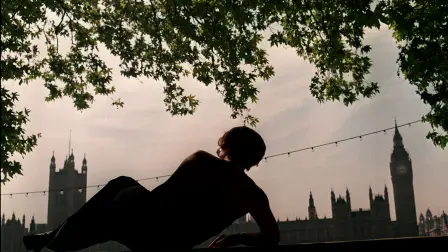 A tourist in London enjoys the shade on the south bank of the River Thames, 11 August during the current heatwave in the south east of England. Temparatures have been hitting the 30 degree mark, following on from July, which was the UK's hottest month in 150 years. (Photo by PAUL VICENTE / AFP)
