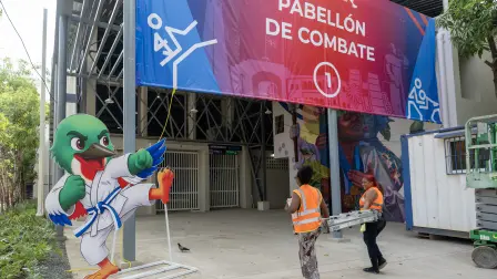 Workers carry a ladder during preparations for the XXV Central American and Caribbean Games in Santo Domingo on July 22, 2026. The XXV Central American and Caribbean Games - Santo Domingo 2026, will be held from July 24 to August 8, 2026, in the Dominican Republic. (Photo by Francesco SPOTORNO / AFP)