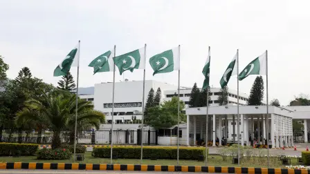 FILE PHOTO: Pakistani flags flutter near the Parliament House, as delegations from the United States and Iran are expected to hold peace talks, in Islamabad, Pakistan, April 11, 2026. REUTERS/Akhtar Soomro   REFILE - CHANGING FROM "HIGH-STAKE TALKS" TO "PEACE TALKS"./File Photo