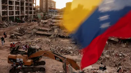 A Venezuelan flag waves as people search for the bodies of their loved ones beneath the rubble, after earthquakes rocked Venezuela on June 24, killing and displacing thousands of people, in Caraballeda, La Guaira, Venezuela, July 29, 2026. REUTERS/Gaby Oraa
