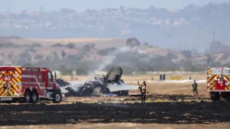 Fire crews spray down the wreckage of a US Marines F-35B fighter jet after it crashed into a field near Miramar Air Base in San Diego, California, on July 31, 2026. A US F-35 fighter jet crashed Friday near a military base in San Diego, but the pilot was able to eject before impact, officials said. "There was an aviation mishap involving a Marine Corps F-35B in the vicinity" of Marine Corps Air Station Miramar at about 10:00 am (1700 GMT), a spokesman for the base told AFP. (Photo by SANDY HUFFAKER / AFP)