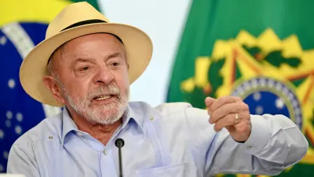 Brazils President Luiz Inacio Lula da Silva gestures as he speaks during the signing ceremony of the new law establishing the national policy on minimum wages for road freight transport at Planalto Palace in Brasilia on August 5, 2026. (Photo by Evaristo Sa / AFP)