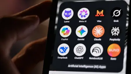 This photograph shows a handheld smartphone displaying the icons of some of the main artificial intelligence based apps, including LLMs, chatbots and generative AI, with logos (from L) of Proton AG's Lumo, Meta AI, Mistral Vibe (formerly Le Chat), xAI's Grok, Microsoft's Copilot, Google's Gemini, Anthropic's Claude, Perplexity, Deepseek, OpenAI's Chat GPT, Google's Notebook LLM and generative AI music app Suno, in Saint-Mande, east of Paris, on July 15, 2026. (Photo by Martin LELIEVRE / AFP)