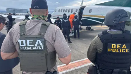U.S. Drug Enforcement Administration (DEA) agents observe alleged drug traffickers Gabriel Lozano, known as "Compadre," (not pictured) and Gilbert Bell Fernandez, known as "Macho Coca," as Costa Rican security forces escort them aboard a plane for extradition to the United States, where they face drug trafficking charges, at Juan Santamaria International Airport in Alajuela, Costa Rica, August 13, 2026. Ministerio de Seguridad Publica/Handout via REUTERS ATTENTION EDITORS - THIS IMAGE HAS BEEN SUPPLIED BY A THIRD PARTY. NO RESALES. NO ARCHIVES.