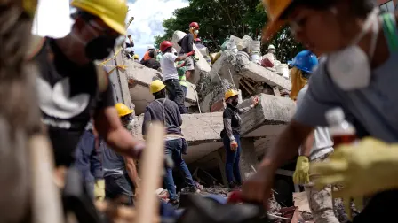 Rescue workers and volunteers work, as search and rescue operations are under way at the site of a destroyed Cantabria building, following the earthquake in Cali, Colombia, August 13, 2026. REUTERS/Sergio Acero