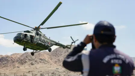 A military helicopter takes off transporting passengers near the site of a mudslide after heavy rains on the Pan-American Highway between Atico and Ocona in Arequipa, southern Peru on August 21, 2026. Military helicopters began evacuating more than 300 passengers on August 21, 2026, who were stranded in southern Peru due to a mud and rock slide that blocked a section of a highway in the Arequipa region, AFP observed. (Photo by Juan Santy / AFP)