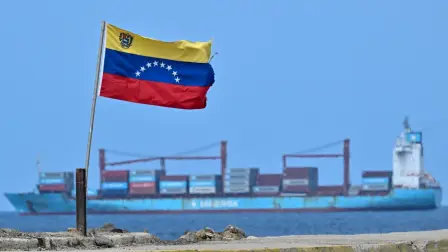A Venezuelan flag waves as a cargo ship sails at La Guaira Port, Venezuela on August 22, 2026. The Venezuelan Parliament announced an investigation into opposition lawmaker Antonio Ecarri on August 22, 2026, and removed him from his legislative post after he proposed dollarizing the economy with the advice of US economist Steve Hanke. (Photo by Juan BARRETO / AFP)