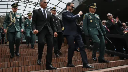 Colombia's President Abelardo de la Espriella (C) and his Defense Minister Jorge Mora (2nd L) descend from the stands to receive military honors during the change of command ceremony at the Jose Maria Cordova Military School in Bogota on August 26, 2026. Colombia's new hard-right government announced on August 25, 2026, plans to classify guerrilla fighters, drug traffickers and other criminal groups as "terrorists." (Photo by Raul ARBOLEDA / AFP)