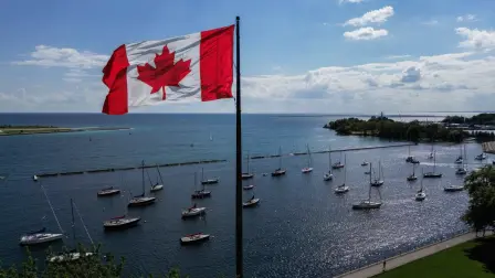 A Canadian flag flies along the waterfront of Lake Ontario, in Toronto, Ontario, Canada, on August 27, 2026. US President Donald Trump announced that he is renaming Lake Ontario -- a large body of water shared by the United States and Canada -- "Lake America." Trump signed an order in the White House in a move that comes amid a spiraling trade war between the world's largest economy and its northern neighbor. (Photo by Cole Burston / AFP)
