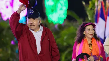 (FILES) This handout picture released by Nicaragua's government via the official El 19 Digital news outlet shows Nicaragua's President Daniel Ortega waving next to wife and co-President Rosario Murillo during an event to commemorate the 47th anniversary of the Nicaraguan Revolution in Managua, on July 19, 2026. "All they can do is bark," replied President Daniel Ortega in response to the widespread international condemnation of his decision to formally ban opposition candidates from standing in the Nicaraguan elections, where he rules with absolute power alongside his wife, Rosario Murillo. The Congress announced that in September, 2026 it will pass a constitutional reform establishing a "renewable" seven-year presidential term  the mechanism for which it did not specify  and excluding opposition parties, which Ortega describes as "coup plotters" in the "service" of the United States. (Photo by Cesar PEREZ / El 19 DIGITAL / AFP) / RESTRICTED TO EDITORIAL USE - MANDATORY CREDIT "AFP PHOTO / EL 19 DIGITAL / Cesar PEREZ " - HANDOUT - NO MARKETING NO ADVERTISING CAMPAIGNS - DISTRIBUTED AS A SERVICE TO CLIENTS