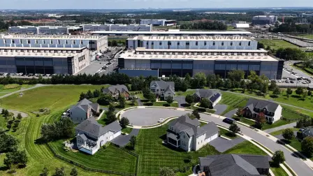 STONE RIDGE, VIRGINIA - AUGUST 26: In an aerial view an Amazon Web Services data center is seen on August 26, 2026 in Stone Ridge, Virginia. In the months leading up to midterms, politicians have increasingly debated whether the economic benefits of new data centers outweigh the concerns over their high energy and water demands and impact on local communities.   Anna Moneymaker/Getty Images/AFP (Photo by Anna Moneymaker / GETTY IMAGES NORTH AMERICA / Getty Images via AFP)