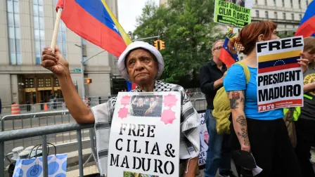 Demonstrators hold signs in support of ousted Venezuelan president Nicholas Maduro and his wife Cilia Flores, outside the Daniel Patrick Moynihan Federal Courthouse in New York City on July 22, 2026. Venezuela's ousted president Nicolas Maduro is set to appear in federal court Wednesday, his third public hearing since the US military captured him in a stunning nighttime raid in January. The former leader, 63, and wife Cilia Flores have been held in a Brooklyn jail since the US military operation, awaiting trial on drug trafficking, firearms and other charges. (Photo by TIMOTHY A. CLARY / AFP)