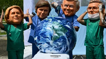 Oxfam activists wearing oversized masks representing (L to R) European Commission President Ursula Von der Leyen, Argentina's President Javier Milei, US President Donald Trump and Britain's Prime Minister Keir Starmer pose during their "Big Heads" protest at Utinga Park in Belem, Para state, Brazil, on November 20, 2025, to simulate a chaotic emergency room and highlight that as the COP30 UN Climate Change Conference ends, the planet is in critical condition. With UN climate talks nearing a close in Belem, the world body's chief on Thursday urged nations to reach an "ambitious compromise" that keeps alive the goal of limiting long-term planetary warming to the critical 1.5C threshold. (Photo by Pablo PORCIUNCULA / AFP)