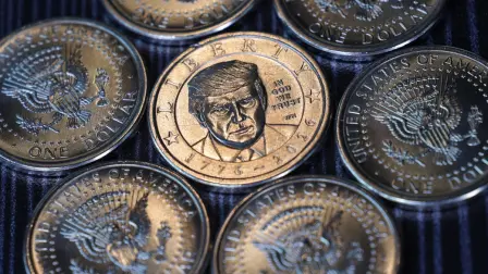 WASHINGTON, DC - SEPTEMBER 03: In this photo illustration, newly minted Donald Trump $1 coins are seen in formation on September 3, 2026 in Washington, DC. The coin was officially released by the U.S. Mint on September 2, 2026 to commemorate the 250th anniversary of American independence, marking the first time a living person has appeared on circulating U.S. coinage since 1866. (Photo illustration by Alex Wong/Getty Images) (Photo by ALEX WONG / GETTY IMAGES NORTH AMERICA / Getty Images via AFP)