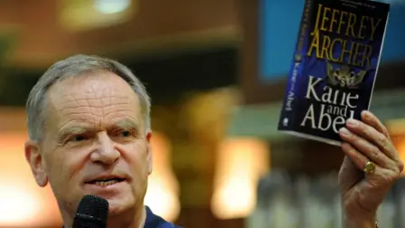 British author Jeffrey Archer holds a copy of his book 'Kane and Abel' during an interaction with readers at a book signing session in Mumbai on May 13, 2009. Archer, is in India on a five city tour for his latest book, " Paths of Glory"- a fictional account of one of the greatest unsolved mysteries in mountaineering history and revolves around the story of George Mallory and his dream of becoming the first person to climb Mount Everest.   AFP PHOTO/Indranil MUKHERJEE (Photo by INDRANIL MUKHERJEE / AFP)